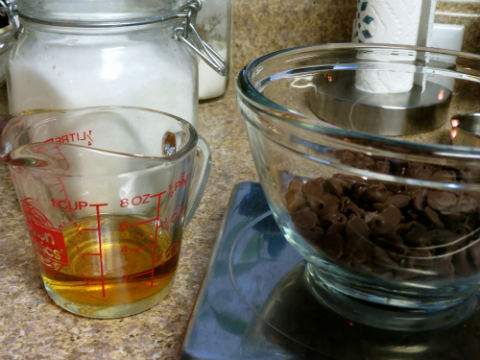 Measuring the bourbon and chocolate for the pie